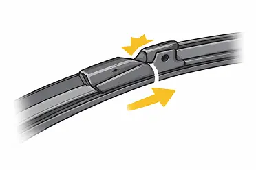 Close-up of a windshield wiper blade with a release tab and yellow arrows showing how to detach it.